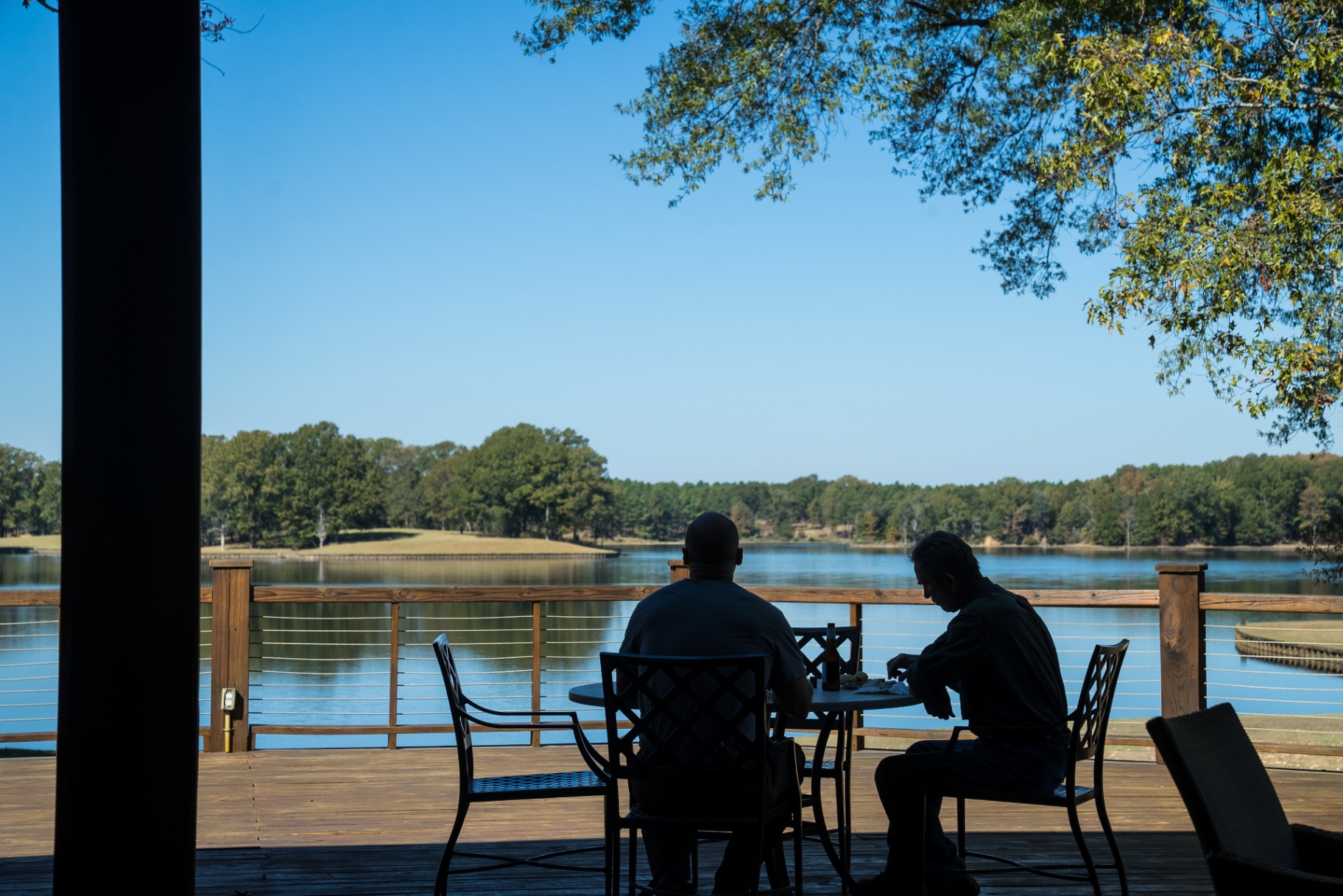 Guests on the lakeside deck at sunset