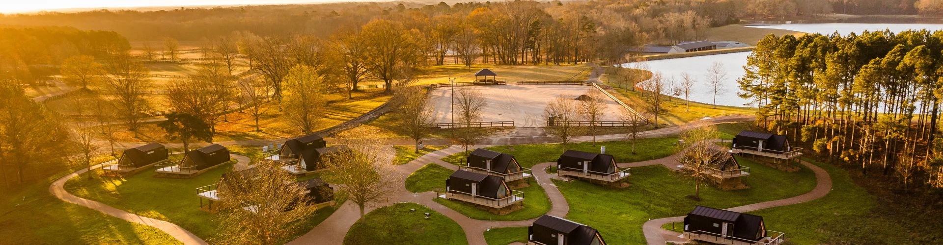 Aerial view of A-frame cabins in morning light