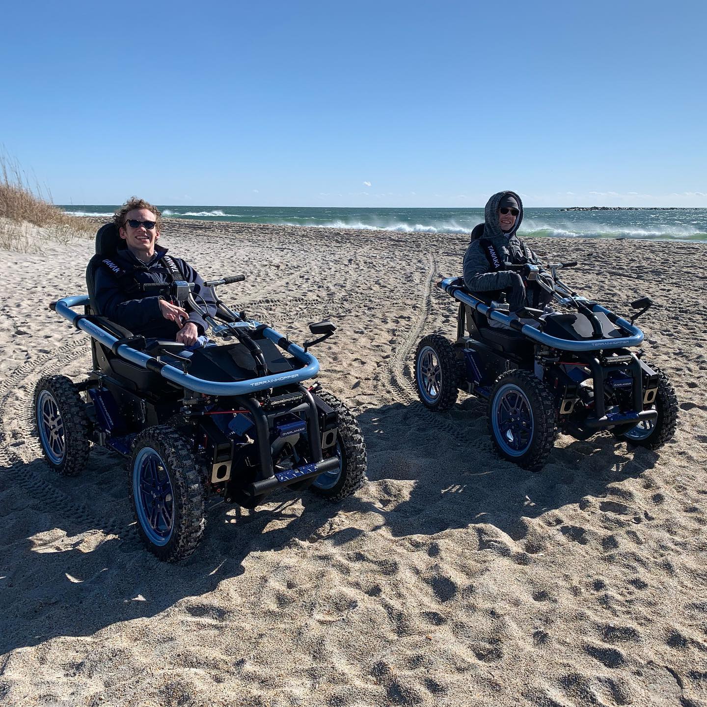 Two TerrainHopper riders on the beach at the shoreline
